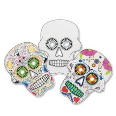 three sugar skulls with different designs on them