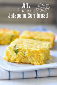 two pieces of cornbread sitting on top of a white plate