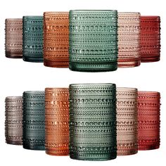 six different colored glass tumblers sitting next to each other