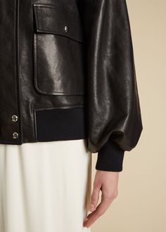 Description With pieces such as this buttery leather jacket, the Pre-Fall collection proposes a wardrobe that is both singular and universal. The shearling collared, zip- and snap-front silhouette combines the clean lines of a moto jacket with the softened volumes of a classic bomber. Finishing touches include a back yoke, patch pockets, and knit insets at the hem and cuffs. Details Material: Textured lamb (100% lambskin), lined in 100% cupro Care: Specialist clean Fit: Designed for an oversized Khaite Coat, Khaite Leather Jacket, Sleek Double-breasted Leather Outerwear, Luxury Double-breasted Leather Jacket With Button Closure, Luxury Leather Single-breasted Outerwear, Pre Fall Collection, Fall Collection, Moto Jacket, Pre Fall