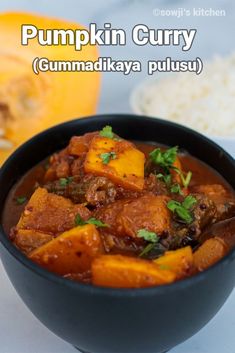 pumpkin curry in a black bowl with rice on the side