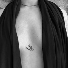 a woman with a small tattoo on her chest