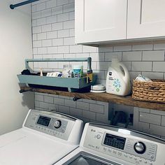 a washer and dryer are sitting on the shelf above the washer in this laundry room