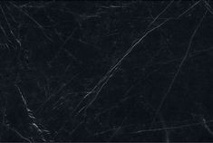 black marble textured with white lines and scratches on the edges, as seen from above