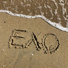 the word expo written in sand on the beach