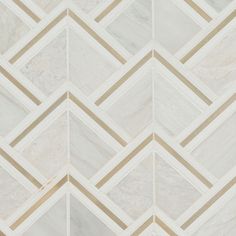 a white and gold tiled wall with lines on the bottom, diagonals at the top