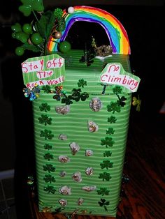 a st patrick's day treat box is decorated with shamrocks and lucky charms