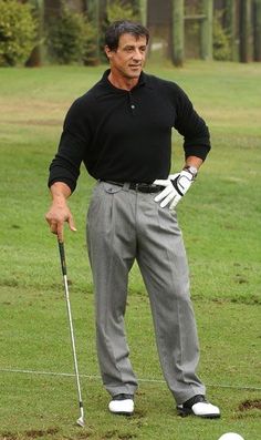 a man standing on top of a lush green field holding a golf club and ball