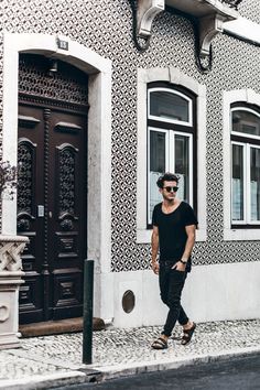 a man standing in front of a building