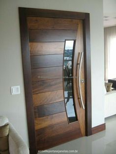 a modern wooden door in the corner of a room