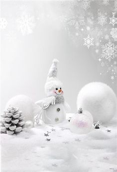 a snowman is surrounded by christmas balls and pine cones on a white background with snowflakes