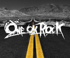 the word one or rock written in graffiti on an empty road with mountains in the background