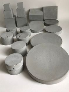 several different shapes and sizes of concretes on a white surface, including one round