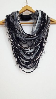 FUN TO WEAR by Unikatina Unique, unusual handmade fabric scarf neckalce Possible to make orders by Your own specification. Product description: Extravagant oversized scarf necklace in black, gray and off white shades. Made from brand new carefuly selected fabric and yarn threads - unusual and unique. Several black strands can slightly vary from photo since each piece is unique and can be changed according to availability of fabric. This piece will make you very fashionable and bring lany clothin Bohemian Black Handmade Scarves, Bohemian Black Handmade Scarf, Burning Man Art, Infinity Cowl, Statement Scarf, Fiber Necklace, Festival Costume, Fabric Scarf, Scarf Necklace