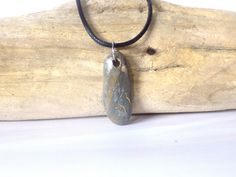 This pendant is made with a coastal stone, either ocean or river. The stone is not tumbled or shaped but is in its natural form, except for the drilled hole. Therefore, the stone/rock will have its natural "imperfections" just as nature made it. This adds character and uniqueness to the piece. They make a perfect gift for rockhounds, yoga\ Zen lovers, surfers or just anyone who loves the beauty of nature. This stone has some really interesting coloration and patterning, that is artistic in itsel Rock Pendant, Natural Form, Boho Style Jewelry, Natural Rock, Beach Stones, Pull Apart, Rock Hounding, Natural Forms, Split Ring