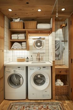 a washer and dryer in a small room with wooden shelves on the wall