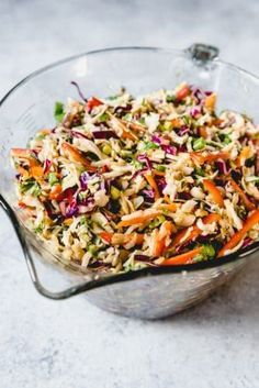 a salad in a glass bowl on top of a table