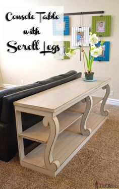 a living room with a couch, coffee table and potted plant on the shelf