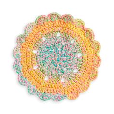 a crocheted doily with multicolored yarn on it, in the shape of a flower