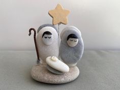 two stuffed animals sitting next to each other on top of a rock with a star