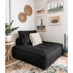 a living room filled with furniture and pictures on the wall