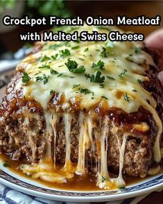 a close up of a plate of food with meatloaf and melted swiss cheese