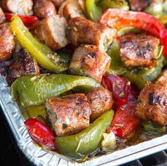 sausage, peppers and onions in a pan with text overlay that reads italian sausage, peppers and onions