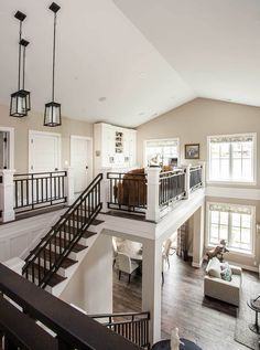 a large open floor plan with stairs leading up to the second story