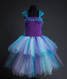 LAST DATE TO ORDER FOR CHRISTMAS  UK Wednesday 13th December  International ~ Sunday 10th December  Ariel ~ inspired by your favourite princess 👑 ️  Our beautiful mermaid tutu is made with yards of soft lilac, turquoise, purple and sparkly tulle finished off with delicate hologram discs. Shoulder straps are adjustable. PLEASE NOTE - As all of my dresses and skirts are made to order I cannot accept returns or exchanges so please double check the size you need when ordering or get in touch if you Ariel Fancy Dress, Ariel Sparkly Blue Dress, Ariel Sparkly Dress, Ariel Purple Dress, Ariel Tutu Dress, Mermaid Tutu, Girls Costumes, Last Date, Beautiful Mermaids