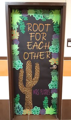 a classroom door decorated with an image of a cactus and the words root for each other