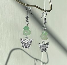 Aventurine is said to balance the heart and release a grounding energy. Paired with a cute silvery butterfly charm, these earrings are inspired by forest fairies and are handmade with love and care. Fairycore Butterfly, Forest Fairies, Grounding Energy, Forest Fairy, Butterfly Charm, May 22, Green Aventurine, Jewelry Earrings Dangle, Hippie Boho