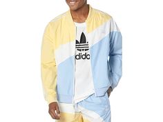 adidas Originals Swirl Woven Track Jacket - Men's Clothing : Almost Yellow/Blue Dawn : The primary materials that compose this product contain a minimum of 20 percent recycled content. Get ready to work vigorously on the ground by wearing adidas Originals Swirl Woven Track Jacket. Relaxed fit. Pullover styel. Mock neck. Long sleeves. Front half zipper closure. Triple stripes on the shoulder. Ribbed cuffs and hemline. Color-blocked design. 100% recycled polyester. Machine wash, line dry. Imported Blue Dawn, Apparel Design Inspiration, Taffeta Fabric, Adidas Track Jacket, Mens Adidas, Adidas Originals Superstar, Wind Jacket, Stand Up Collar, Sign Off