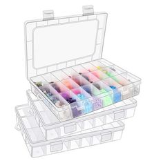 an open plastic box filled with lots of different colored paints and watercolor pencils