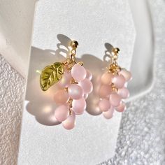 Sweeten up your style with these Bohemian peach candy color glass bead earrings. Skilled artisans handcraft glossy Czech glass beads in juicy peach and melon hues to mimic ripe fruit. Hung from slim threader closures, these delicate earrings add a pop of summery color to everyday outfits. The lightweight beadwork dances gracefully with movement. Handmade using time-honored glasswork techniques, each pair features unique variations in the sizes, shapes and vibrant colors of the peach beads. Treat Peach Candy, Handcrafted Beaded Jewelry, Grape Earrings, Headpiece Accessories, Juicy Peach, Peach Earrings, Glass Bead Earrings, Fruit Jewelry, Ripe Fruit