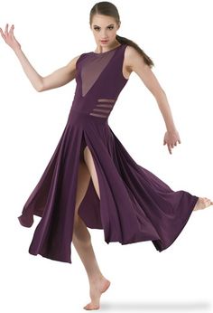 a woman in a purple dress is dancing with her legs spread out to the side