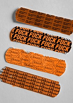 three orange and black stickers with words on them