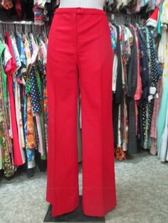 Original deadstock 70s flared red pants. NOS 70s trousers. Made in Italy. Woollen cloth. High waist and no pockets. Mint conditions. They fit about size 30 US Size 40 EU Measurements: (lay flat and double waist and hips) Waist 30"/77 cms rise 10.6"/27 cms hips 39.3"/100 cms inseam 33.4"/85 cms  bottom width 12.6" X 2/32 cms X 2 In order to avoid any unpleasant misunderstandings please read carefully all the items description before purchasing I measure all my items accurately and give the exact Vintage Red Pants For Fall, Retro Full-length Red Pants, Retro Red Full Length Pants, Red Retro Full-length Pants, Red Full Length Retro Pants, Vintage Red Wide Leg Pants, Retro Fitted Red Pants, Fitted Red Wide Leg Pants, Vintage Red Full-length Pants