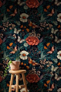 a flower wallpaper with flowers and butterflies on the wall next to a wooden stool