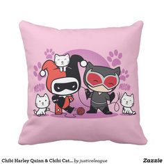 a pink pillow with an image of two cats and a catwoman on it's side