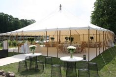 a tent set up with tables and chairs