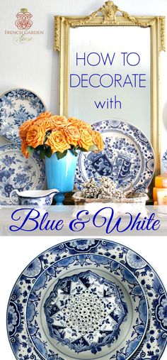 blue and white plates sitting on top of a table next to a vase with flowers