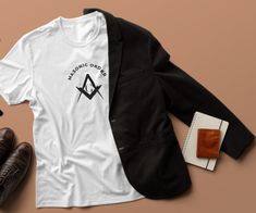 We introduce our latest addition to the family. Our Masonic Order Unisex Shirts.  This Design is made with our very own Soft Flex Vinyl and comes on two different shirts Shirt Features Below Our Unisex Flex Soft Tee 4.5-ounce, 100% ring spun cotton Seamless double-needle 3/4" neck Taped neck and shoulders Semi-fitted Rolled forward shoulders for better fit  SIZESSMLXL BODY LENGTH28293031 BODY WIDTH18202224 SLEEVE LENGTH15.621718.520 Bella 3001 Unisex T-shirt Features: Sideseamed. Retail fit. Uni Prince Hall Mason Shirt, White Cotton T-shirt With Custom Logo, Masonic Order, Clothing Care, Unisex Shirts, The Family, Hoodie Fashion, Cotton T Shirt, Unisex T Shirt