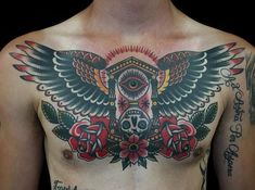 a man with tattoos on his chest has an owl and roses tattoo on his chest