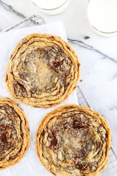 three cookies sitting on top of a cooling rack