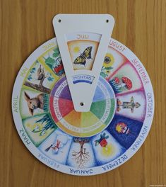 a wooden table topped with a colorful wheel of fortune