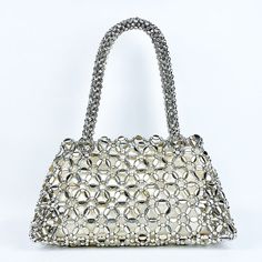 Featuring a hollow exterior adorned with intricate circular patterns, this bag exudes a unique and modern aesthetic that captures attention wherever you go. Its versatile design seamlessly complements a wide range of outfits, making it perfect for various occasions. Crafted from premium quality materials, the Lustrous Handbag exudes luxury and durability, ensuring it stands the test of time. Now available in gold and silver. Chic Silver Handheld Shoulder Bag, Elegant Satchel Bucket Bag For Party, Elegant Hobo Bag With Chain Strap For Shopping, Elegant Satchel Hobo Bag For Party, Silver Satchel Shoulder Bag, Party Shoulder Bag With Chain Strap And Double Handle, Elegant Rectangular Hobo Bag For Parties, Elegant Bucket Bag With Chain Strap, Elegant Hobo Bag With Chain Strap