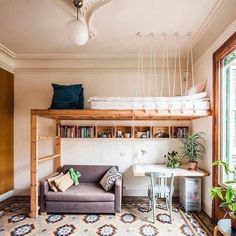 a living room filled with furniture and a loft bed next to a window on top of a rug