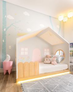 a child's bedroom with a doll house bed