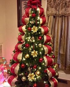 a christmas tree decorated with red and gold ornaments