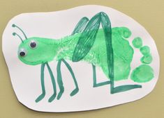 a paper plate with a drawing of a green insect on it's side and the letter l